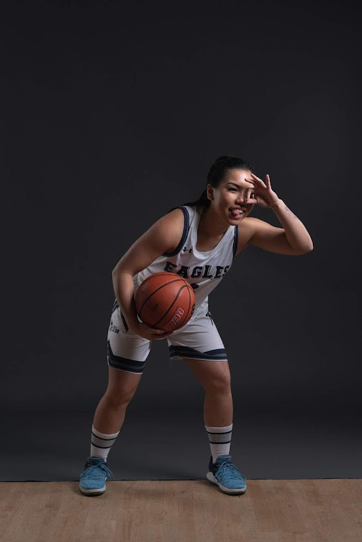 Photo of Jan looking down with back showing in basketball uniform.
