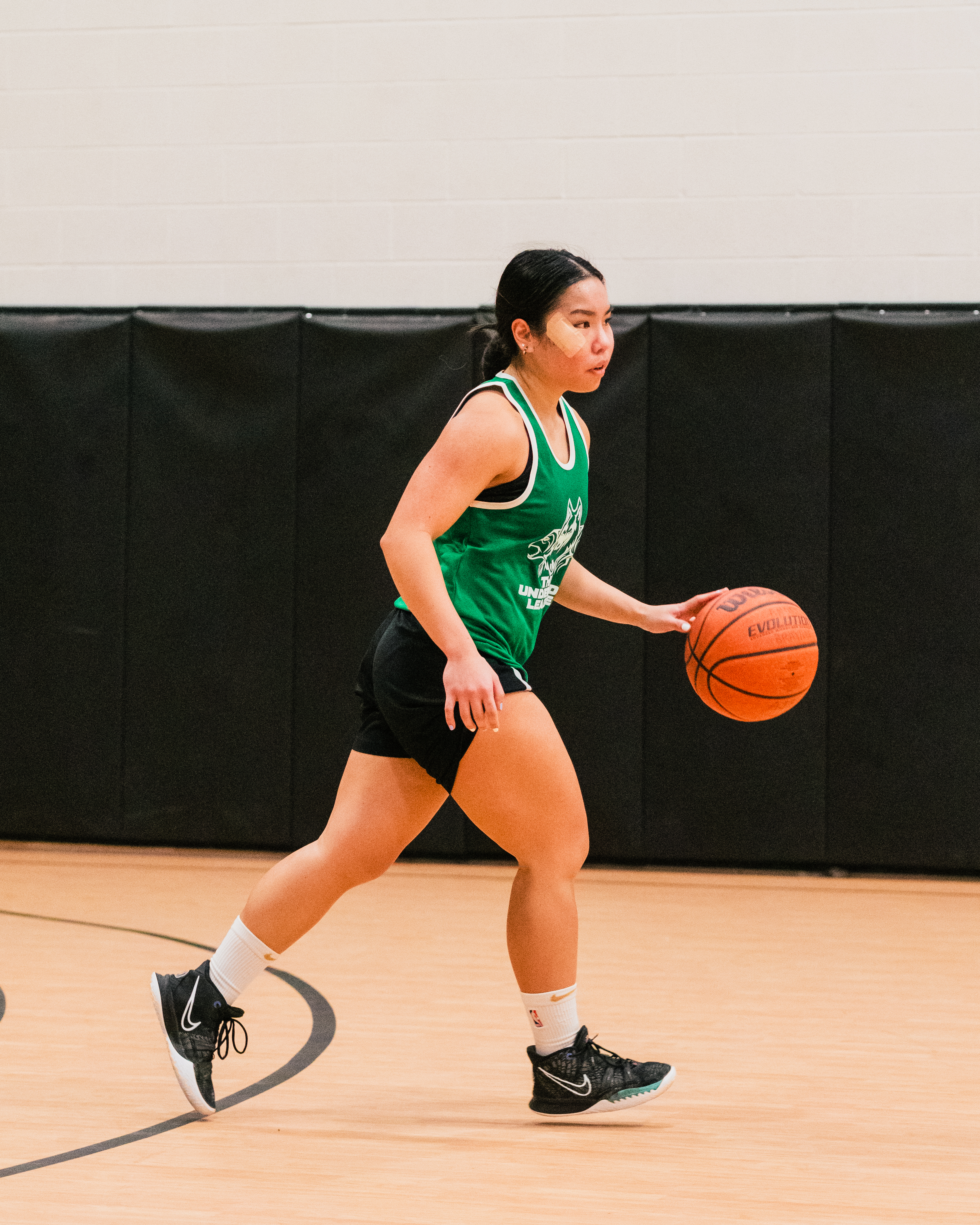 Jan dribbling a ball down the court