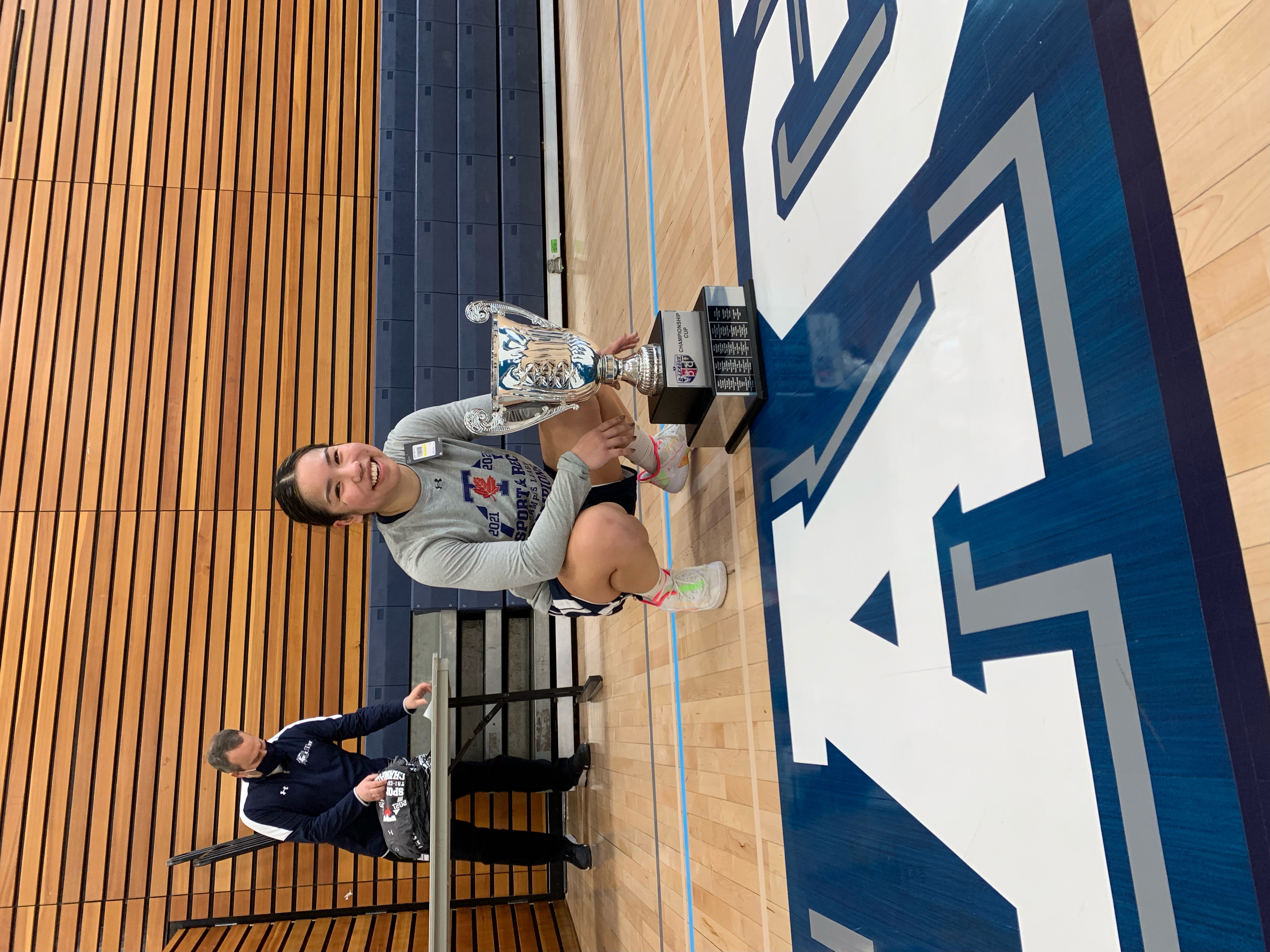 Jan crouching in front of trophy