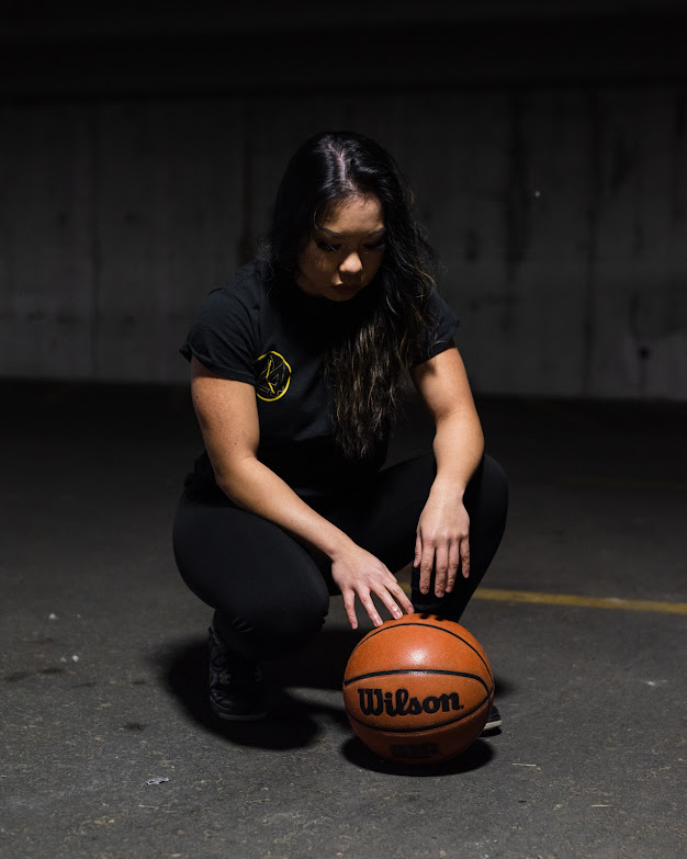 Jan looking down at basketball